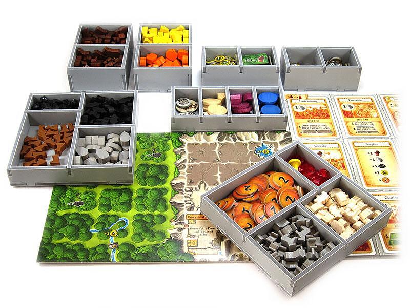 Folded Space Caverna game insert organizer with gray trays filled with wooden game pieces