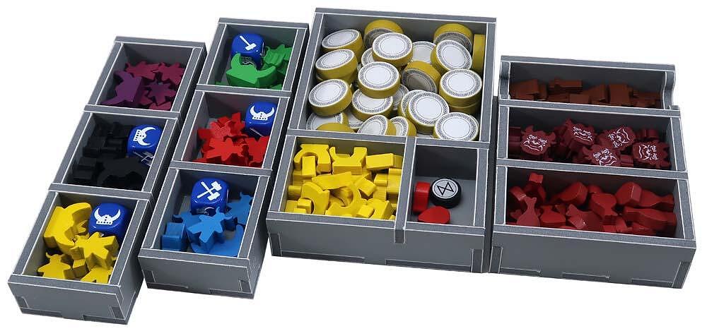 Close-up of organizer compartments holding various game components