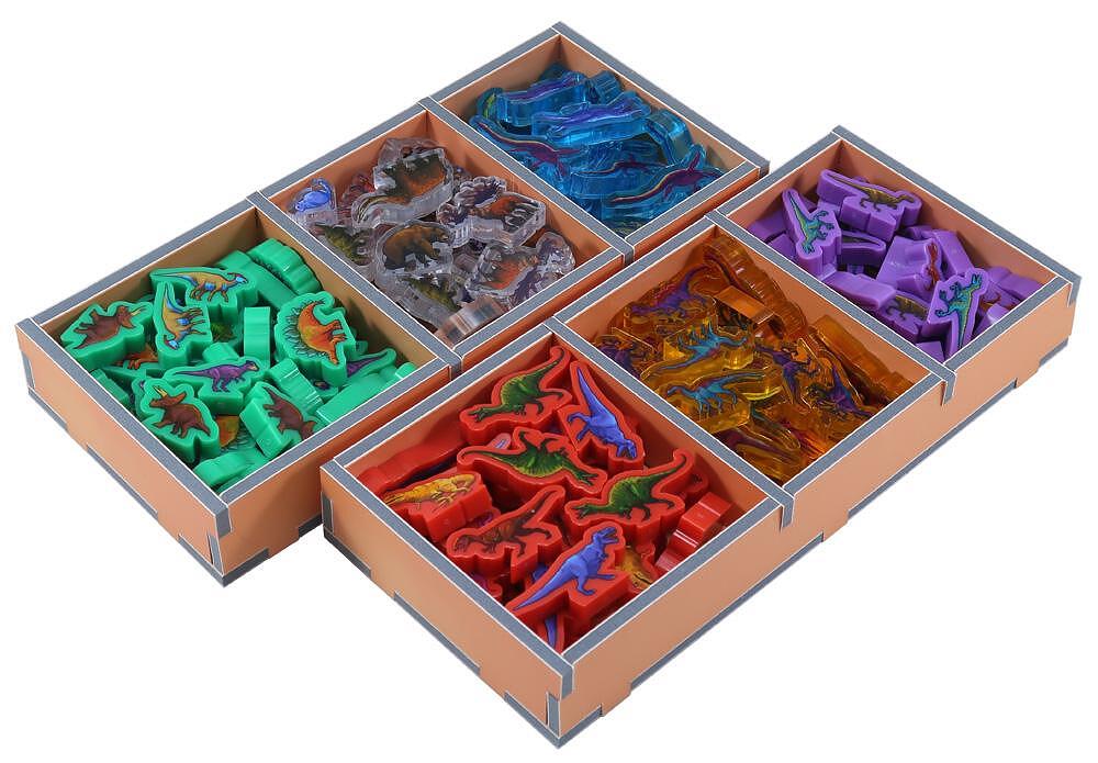 Folded Space Dinosaur World game organizer with multi-colored dinosaur tokens in trays