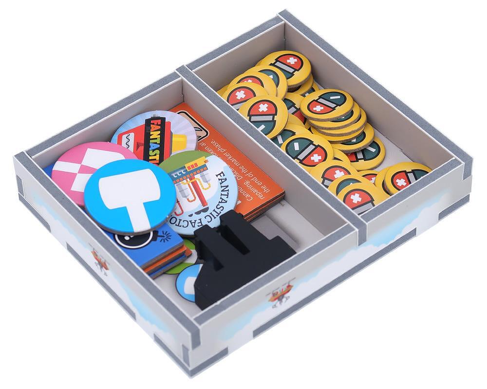 Folded Space insert compartments filled with Fantastic Factories game pieces