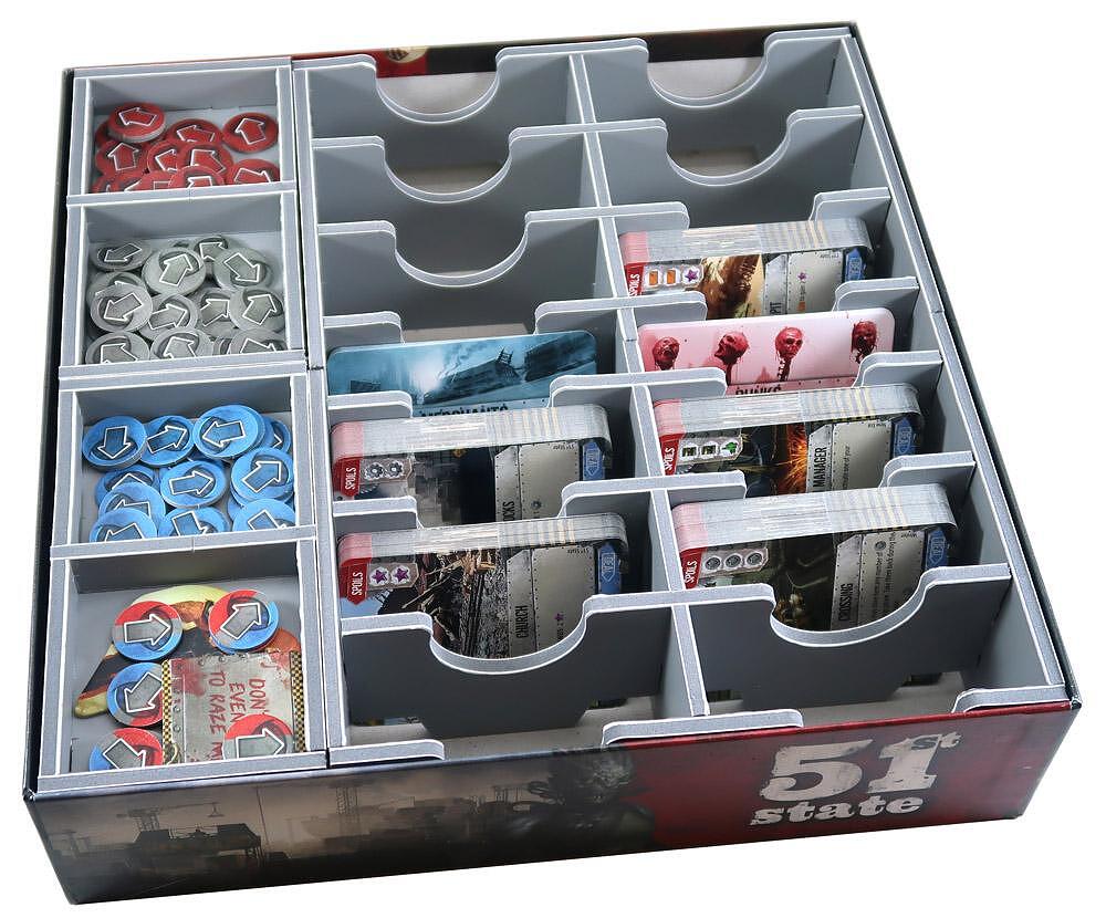 Folded Space insert showing multiple compartments holding various game components
