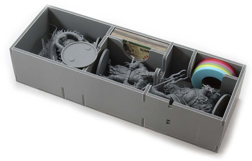 Close-up of game insert compartments storing Rising Sun tokens and cards