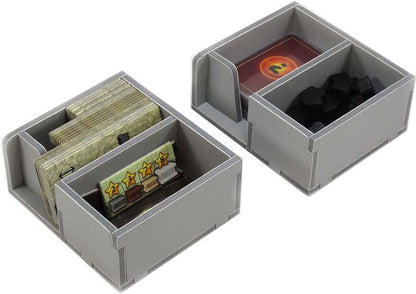 Close-up of the compartments within the Folded Space insert, holding various game pieces of Russian Railroads
