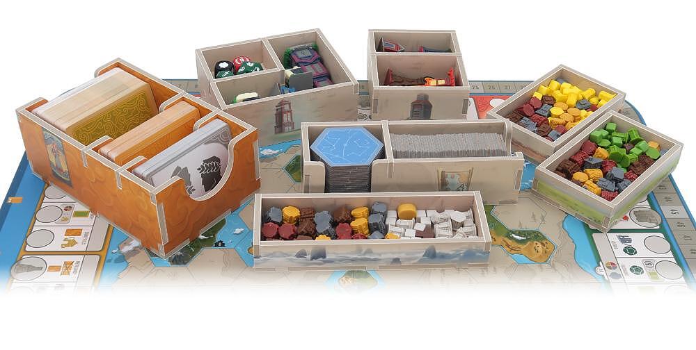 Folded Space Tapestry board game organizer insert with various game components in wooden trays