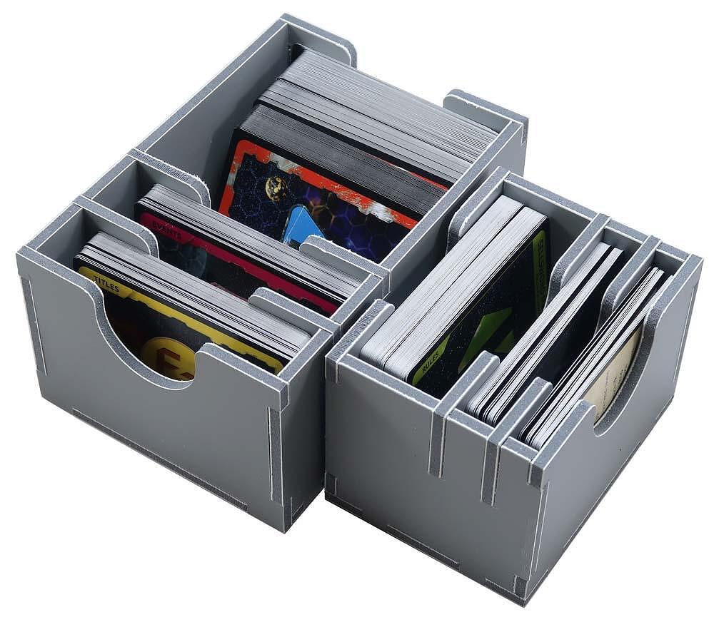 Grey modular card organizer holding stacks of game cards with visible colorful artwork