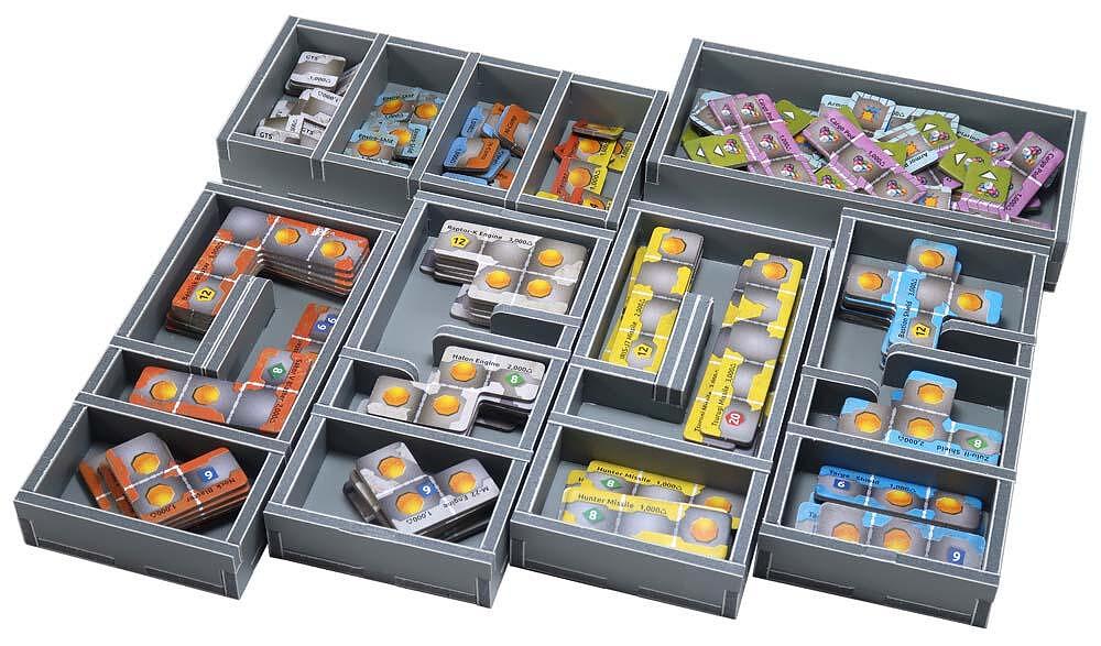 Colorful board game tiles, including ship engines and missiles, meticulously sorted into a gray custom organizer