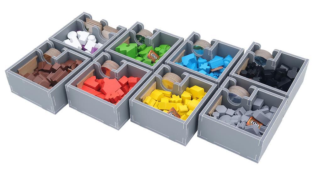 Board game organizer trays filled with game pieces in various colors