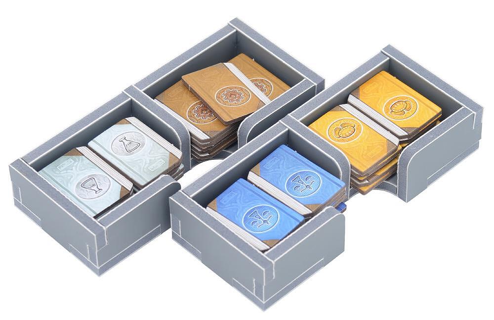 Board game resource tokens in storage trays