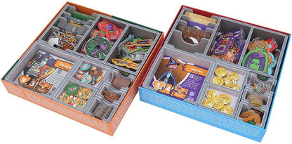 Two board game boxes, one orange and one blue, filled with game pieces and organizers.