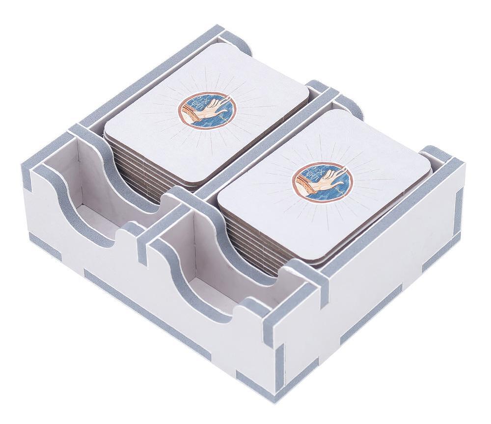 White wooden board game card holder with gray trim, stacked with cards featuring a hand design