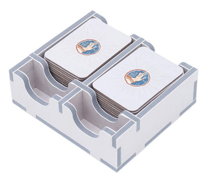 White wooden board game card holder with gray trim, stacked with cards featuring a hand design