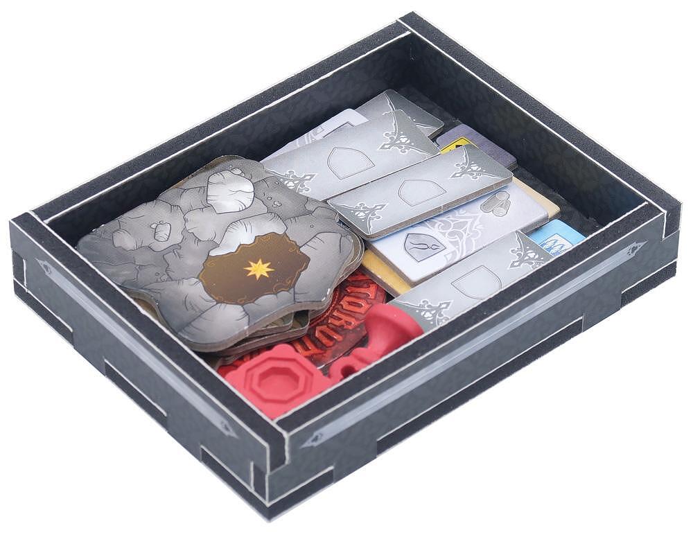 Board game tokens including a stone cave piece, silver pieces, and red tokens in a black box