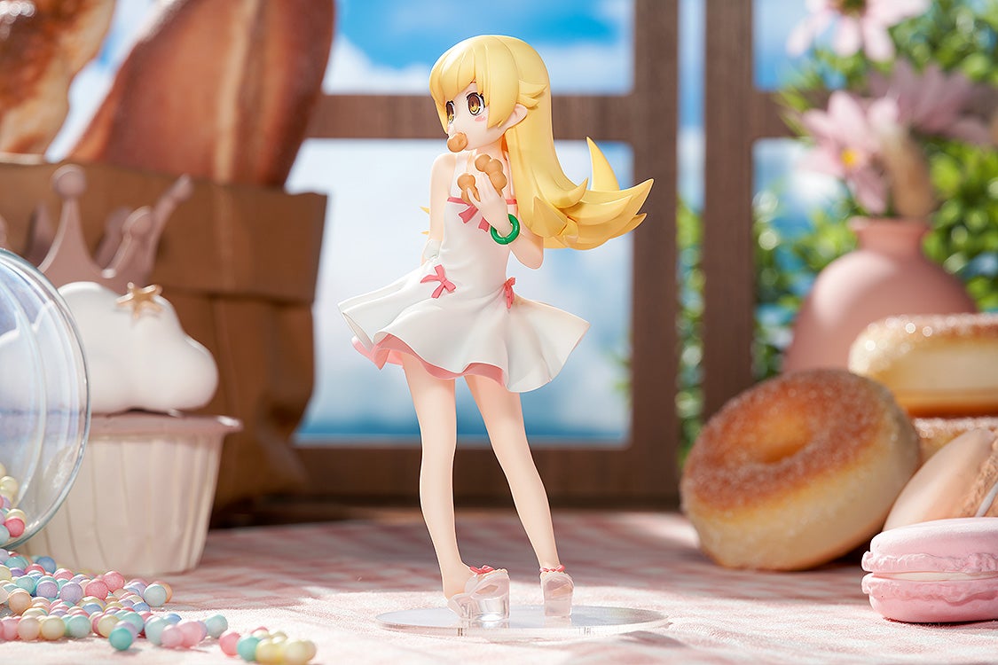 Blonde anime girl figure in a white dress, holding cookies and eating one, surrounded by donuts, macarons, and candies