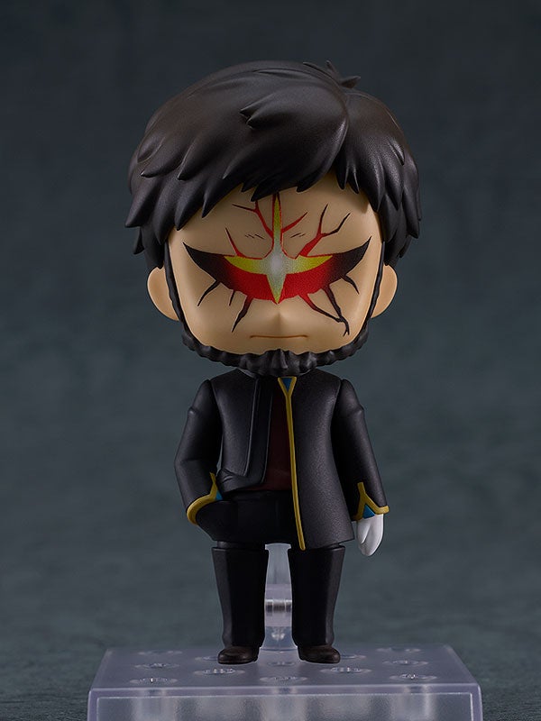 Nendoroid of a man with dark hair, beard, and red/yellow crack-like markings on his face, wearing a dark jacket, standing