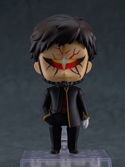 Nendoroid of a man with dark hair, beard, and red/yellow crack-like markings on his face, wearing a dark jacket, standing