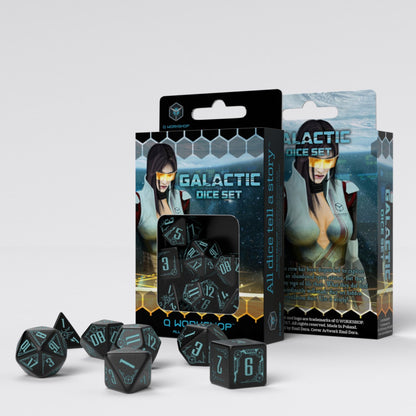 Dark polyhedral dice with glowing blue numbers from a 'Galactic Dice Set,' arranged around their sci-fi themed box