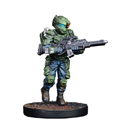A miniature sci-fi soldier in green armor with a blue visor and red helmet lights, holding a rifle