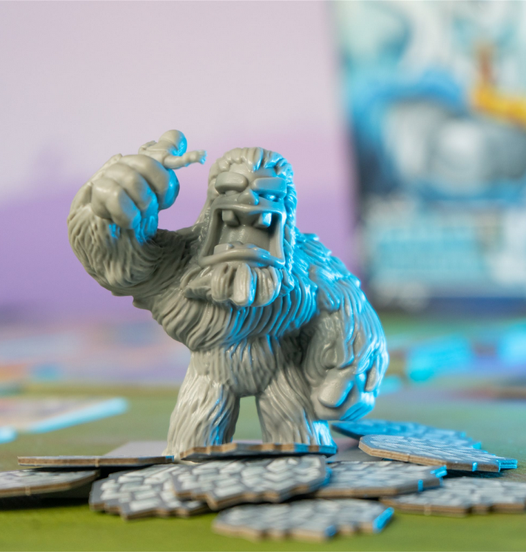 Gray yeti game piece holding tiny human figure