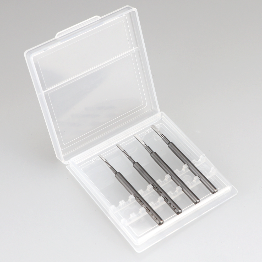 Four dark gray precision tools with chisel tips in an open clear plastic case
