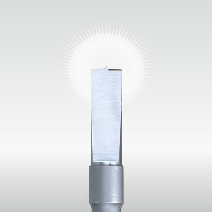 A gleaming metal tool with a small notched tip, centered against a bright, radiating light