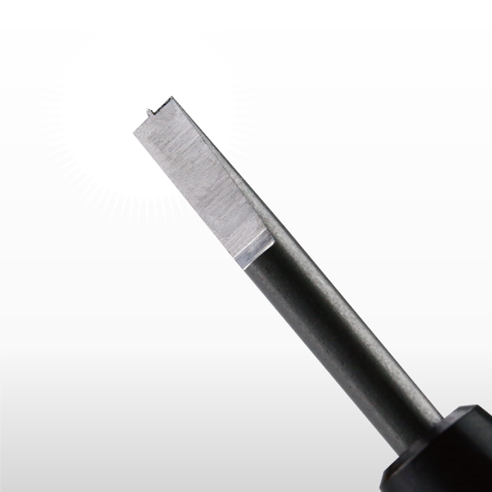 A metal tool with a flat, rectangular tip and a small, central notch, used for specialized cutting