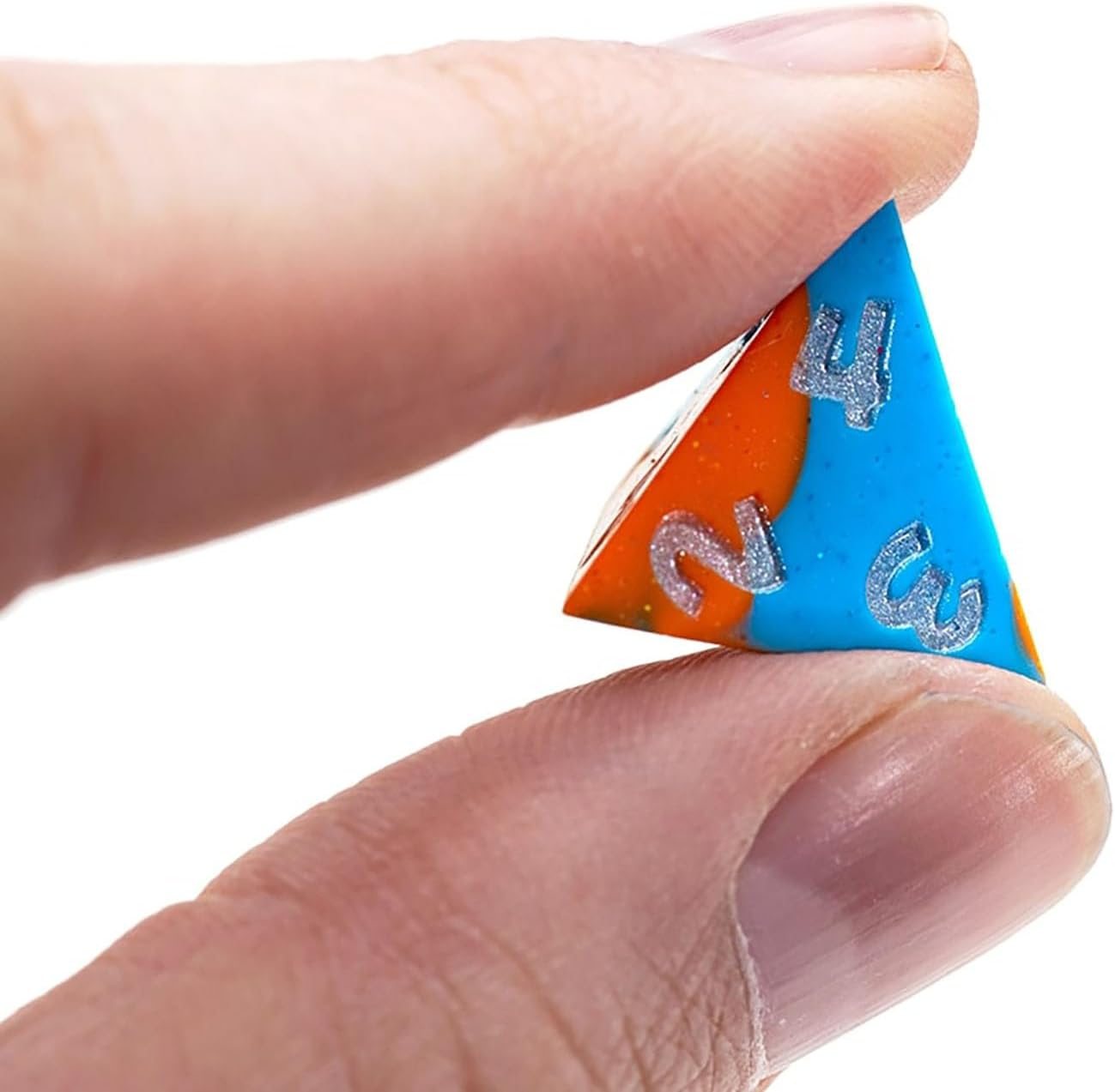 A hand grips a blue and orange Anti-Stress Dice D4, displaying silver numbers 2, 3, and 4