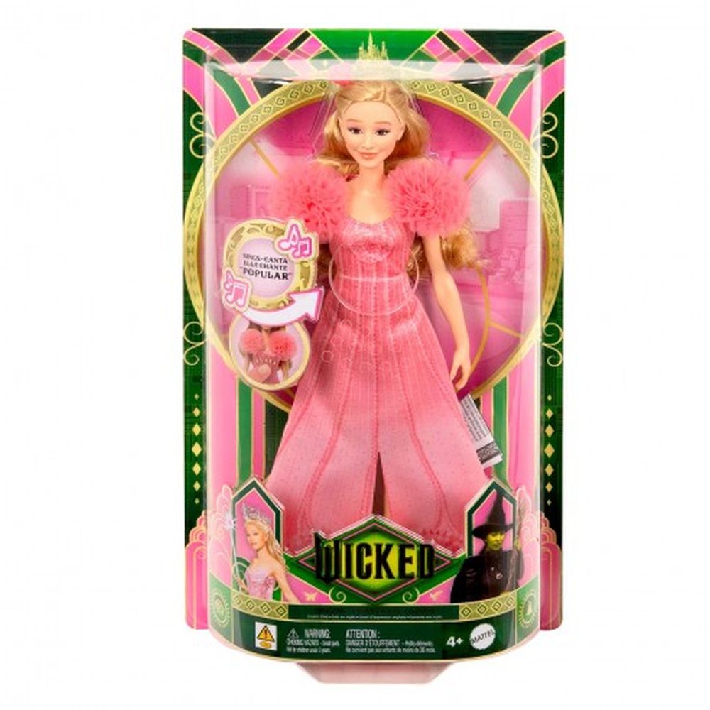 A Disney Wicked Singing Glinda doll in a clear pink and green box wears a long pink dress with fluffy shoulders and a tiara, featuring music notes and the prominent 'Wicked' logo