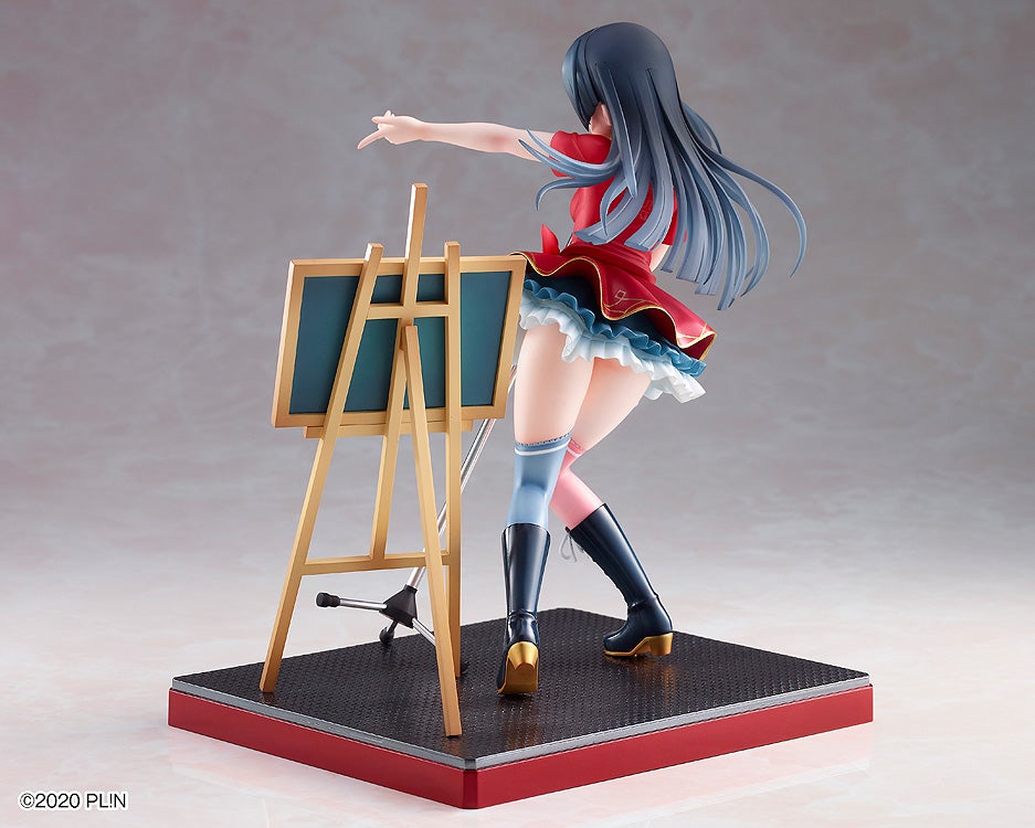 Anime figure in red dress, boots, and flowing hair gestures towards an easel with a green board.