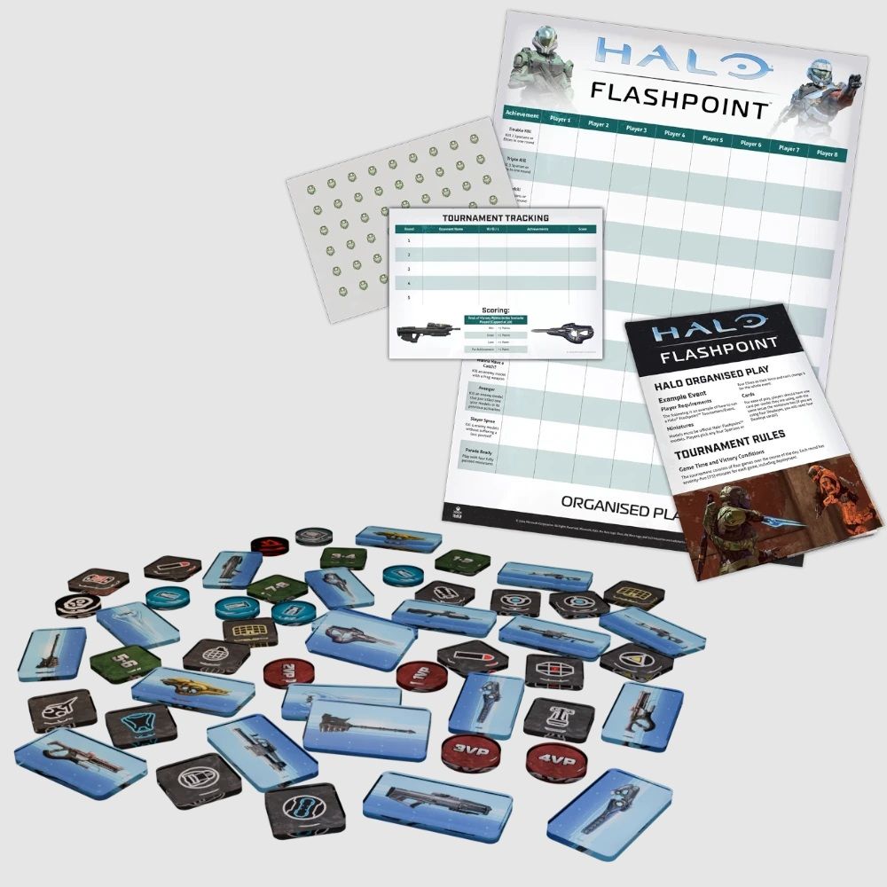 Halo Flashpoint game components: A scoreboard, rule sheets, and many scattered tokens including weapons