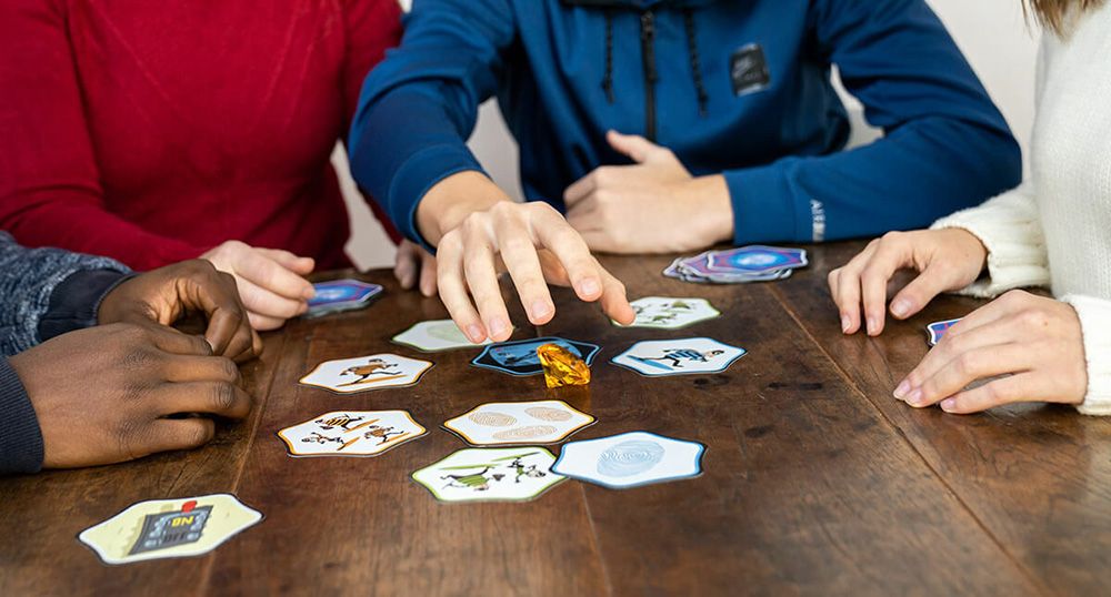 Close-up of Hands Up card game cards fanned out in players’ hands during gameplay