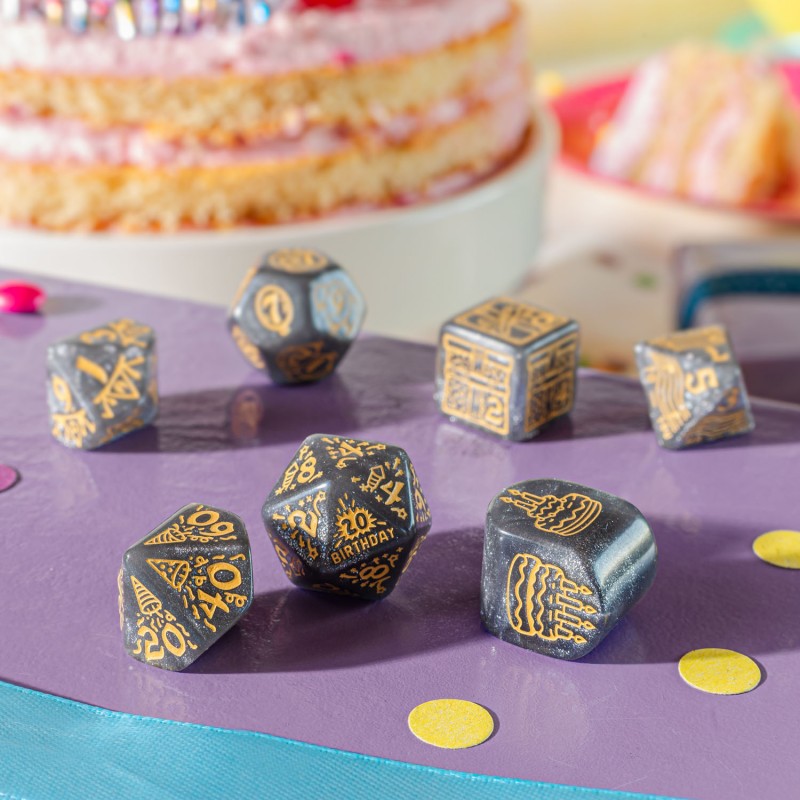 Image showing different dices of Q Workshop’s Happy Birthday D7 Dice Set Confetti sitting on purple table