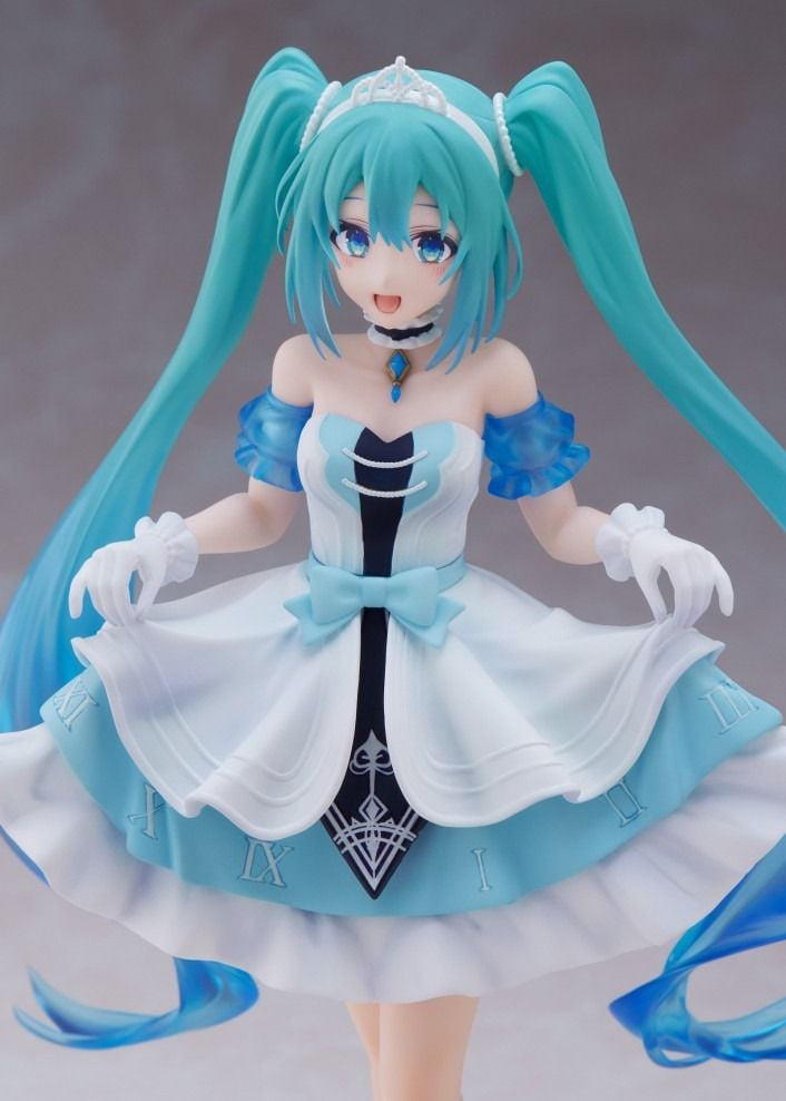 Hatsune Miku anime figure wearing a detailed blue and white princess outfit, teal twintails, tiara, and white gloves
