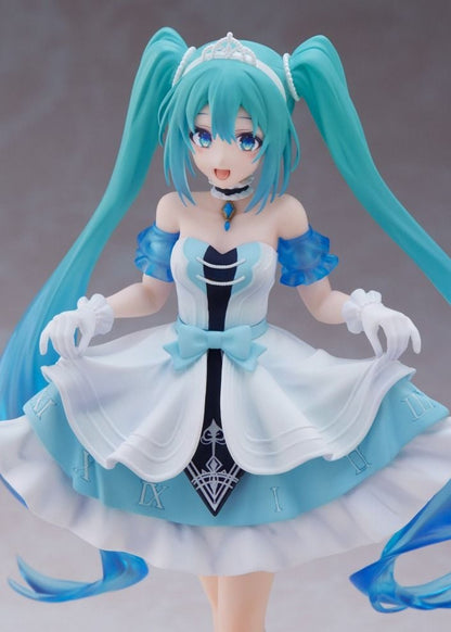Hatsune Miku anime figure wearing a detailed blue and white princess outfit, teal twintails, tiara, and white gloves