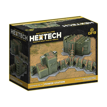 Hextech Power Station tabletop terrain box shows two olive-green sci-fi buildings and connectors on a sandy base.