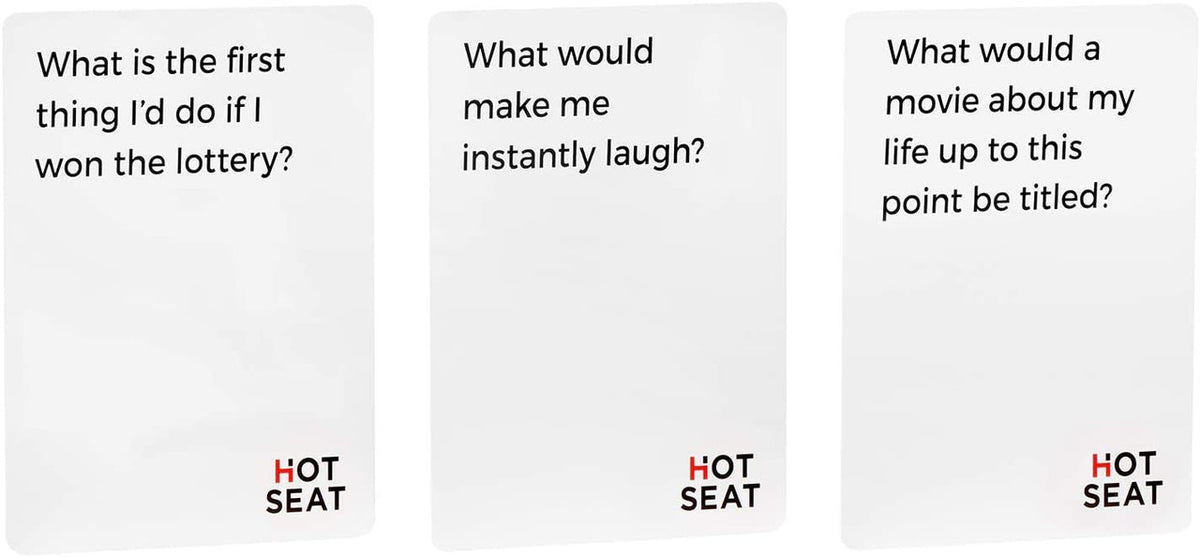 Three white game cards with black text What is the first thing I&#39;d do if I won the lottery What would make me instantly laugh and What would a movie about my life up to this point be titled Each card has HOT SEAT printed in red and black at the bottom