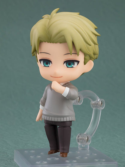 Blonde-haired Nendoroid figure of Loid Forger in a gray sweater, smiling with hand to chest