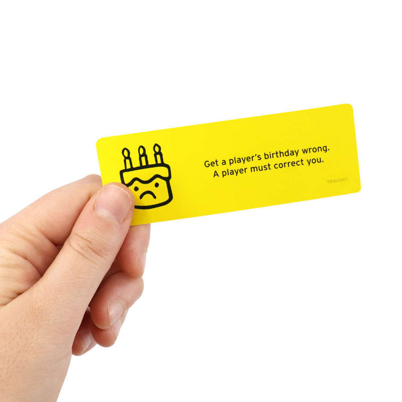 Hand holding a yellow Don&#39;t Get Got Travel game card featuring a sad birthday cake icon and the text Get a player&#39;s birthday wrong A player must correct you