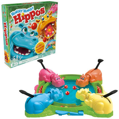 Hungry Hungry Hippos game box and setup: four colorful plastic hippos with levers, eating red marbles