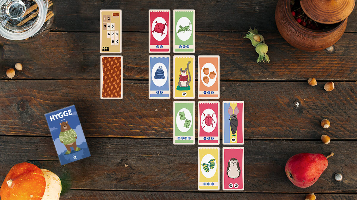 People playing Helvetiq Hygge Card Game for 2-4 Players in a cozy setting