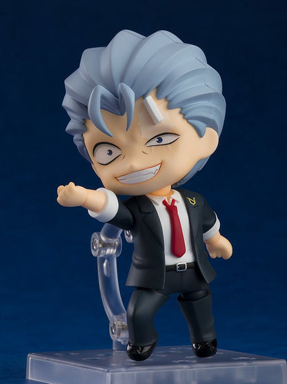 Andy Nendoroid seated casually on a severed head accessory, with playful smile and bandaged body details