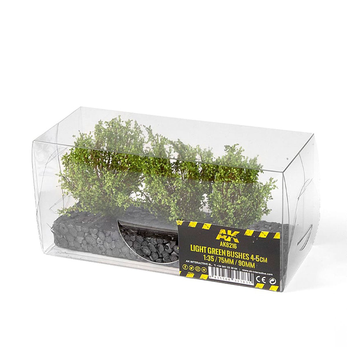 Clear retail box containing light green miniature bushes (4-5cm) on a black base for scale model scenery