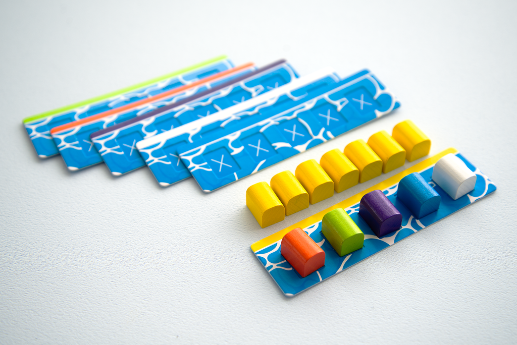 Rafter Five balance puzzle from Oink Games featuring five blue board game pieces and multiple colorful wooden blocks in yellow orange green purple and blue