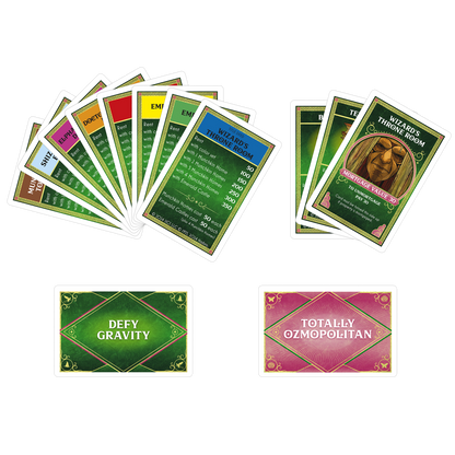 A collection of Monopoly-style Wizard of Oz game cards, including two fanned stacks of property deeds and two action cards below
