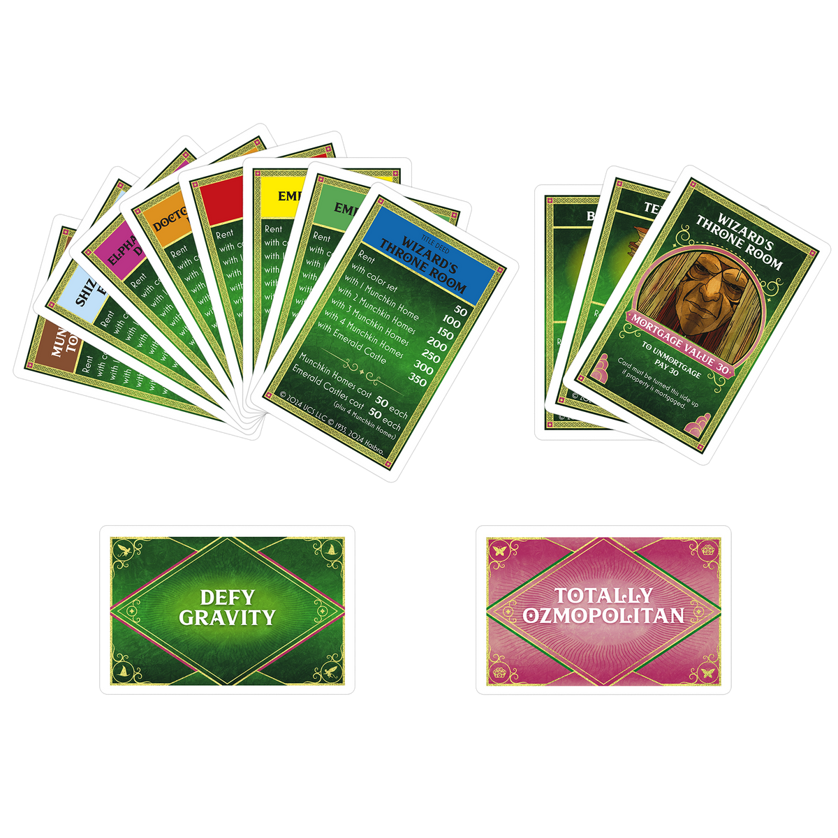 A collection of Monopoly-style Wizard of Oz game cards, including two fanned stacks of property deeds and two action cards below