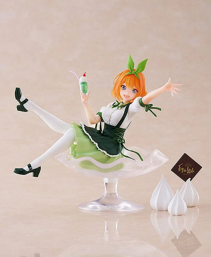 Yotsuba Nakano figure wearing a green and white dress and holding a milkshake sitting in a giant sundae dish on color background