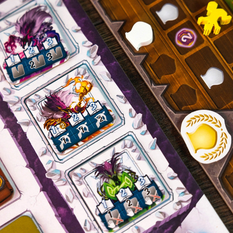 Close up of three colorful fantasy creature game tokens with numerical value tiles on a tabletop game board