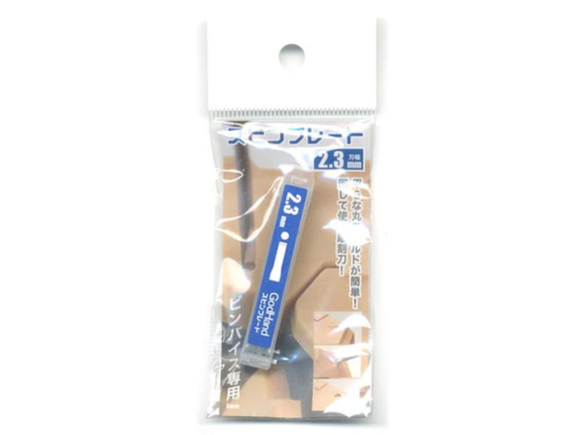 A clear plastic package containing a GodHand  2.3mm precision engraving blade. The packaging features images of it cutting grooves