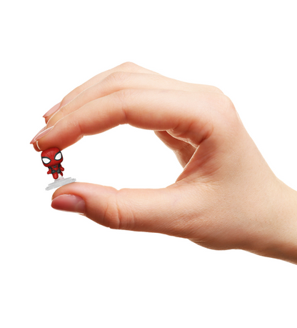 Hand holding a tiny chibi Spider-Man collectible figure on a white stand