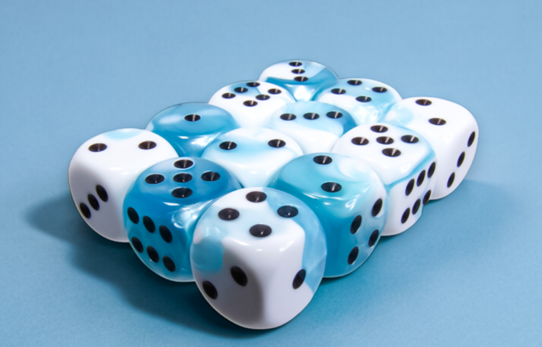 A close-up of numerous teal and white dice stacked in grid layout