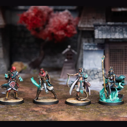 Four detailed fantasy miniature figures, two male & two female, with glowing weapons & magic, set against a blurred temple garden
